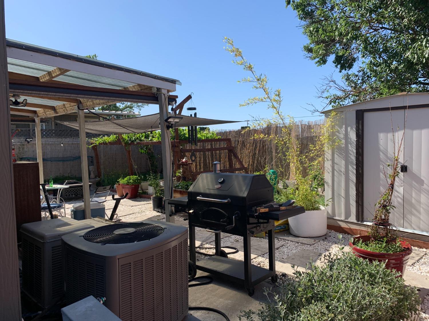 1624 South State Route 99 E Frontage Road, Unit 7 Manteca, CA 95336 - Photo 7 of 12 a view of a patio with table and chairs potted plants and floor to ceiling window