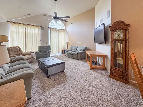 a living room with furniture a flat screen tv and a fireplace