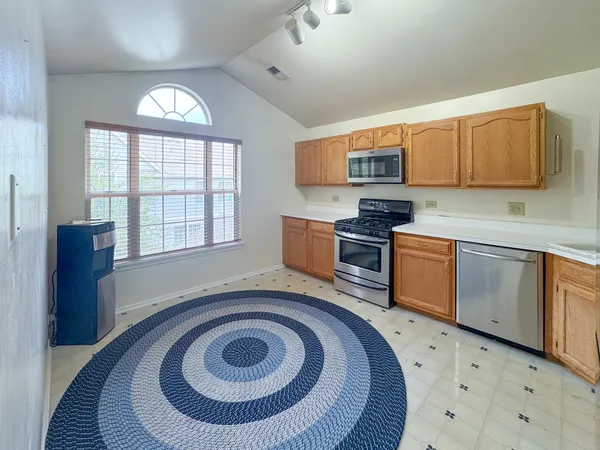 a kitchen with a stove a sink and a microwave