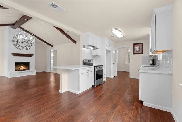 a view of a kitchen with a table and chairs