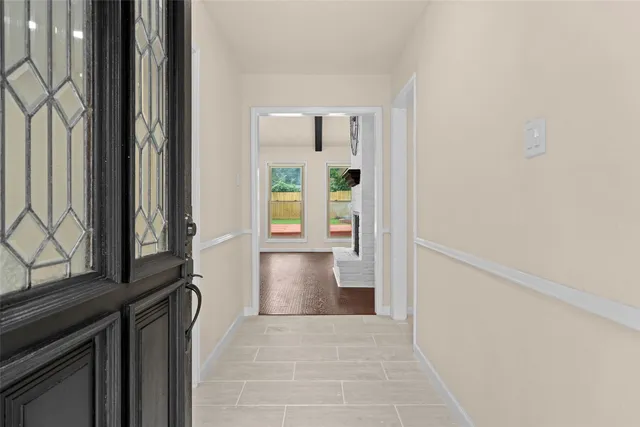 a living room with furniture a clock and a window