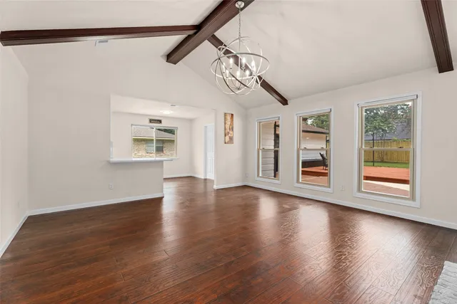 a living room with furniture a flat screen tv and a window