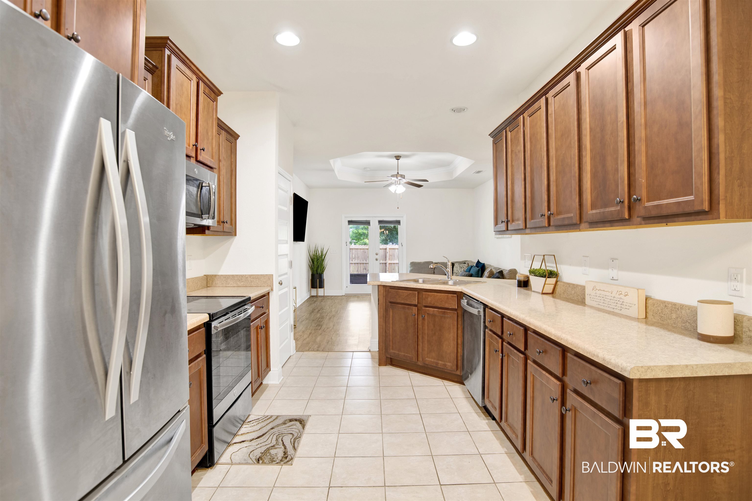 1468 Surrey Loop Foley, AL 36535 - Photo 8 of 28 Kitchen featuring appliances with stainless steel finishes, a tray ceiling, a peninsula, recessed lighting, and ceiling fan