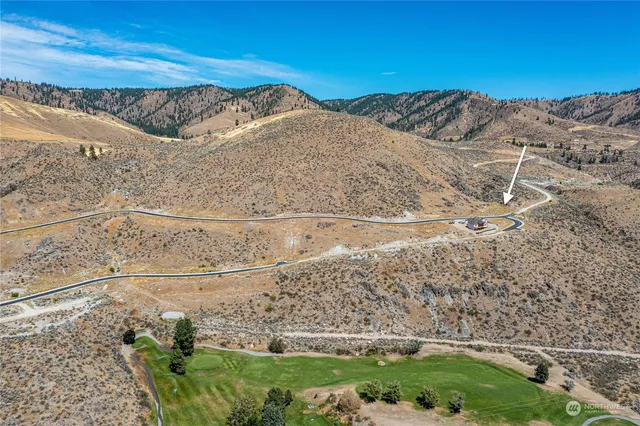 a view of a backyard with wooden fence