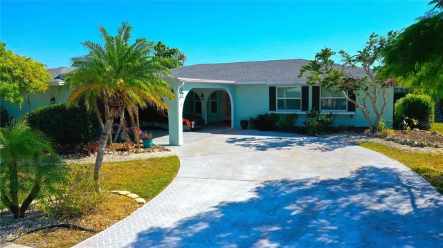 a view of a house with swimming pool and sitting area
