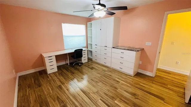 an aerial view of a house with a yard and swimming pool