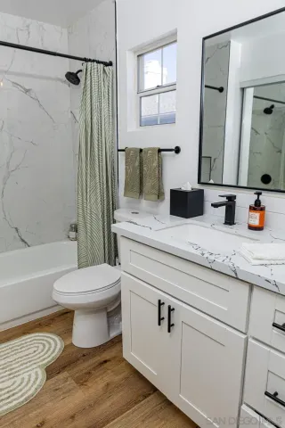 a bathroom with a sink a toilet and a mirror