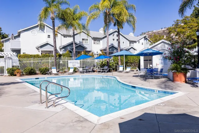 a swimming pool with outdoor seating