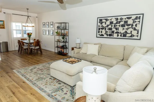 a living room with furniture and painting on the wall
