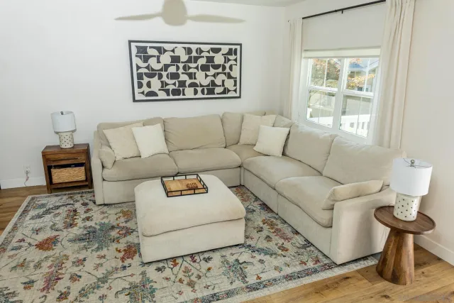 a living room with furniture and a rug