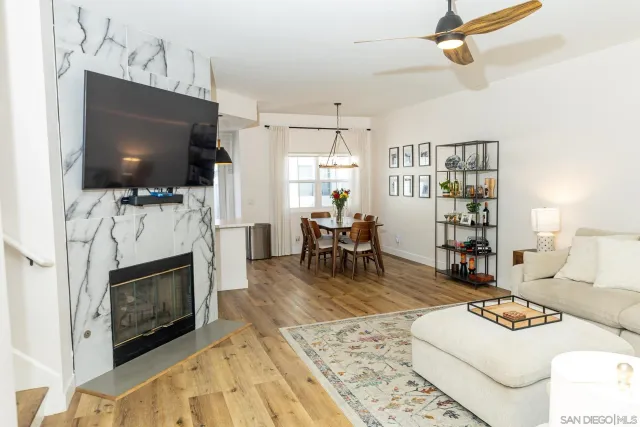 a living room with furniture a flat screen tv and a fireplace