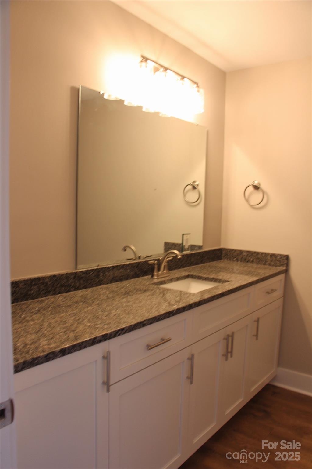 4304 Fletcher Funderburk Road Lancaster, SC 29720 - Photo 12 of 18 a bathroom with a granite countertop sink and a mirror
