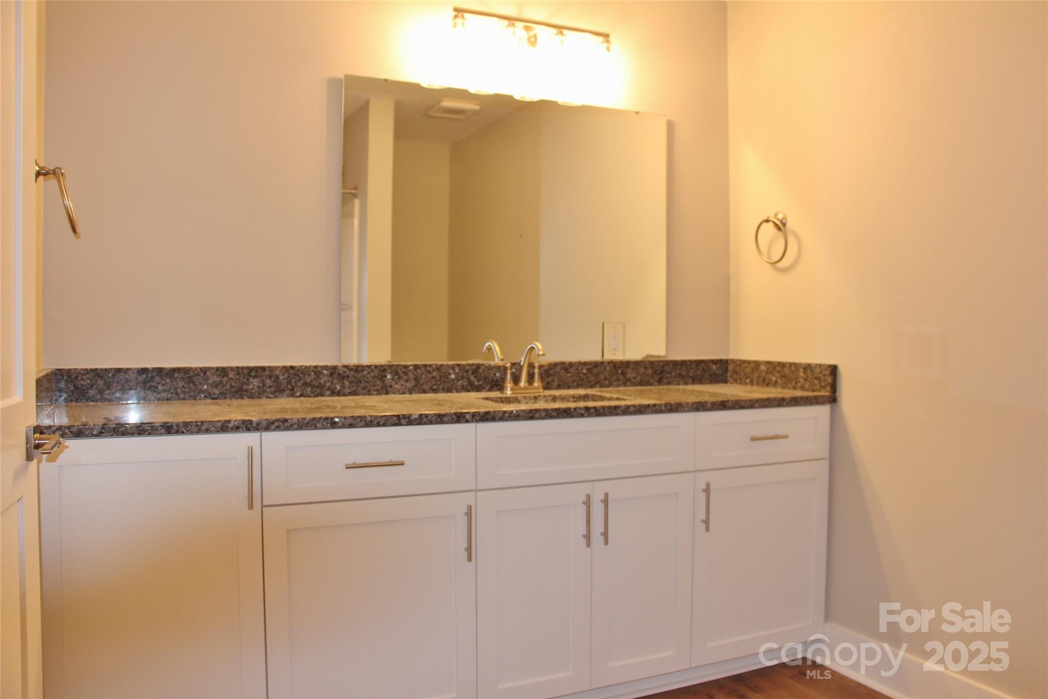 4304 Fletcher Funderburk Road Lancaster, SC 29720 - Photo 13 of 18 a bathroom with a granite countertop sink and a mirror