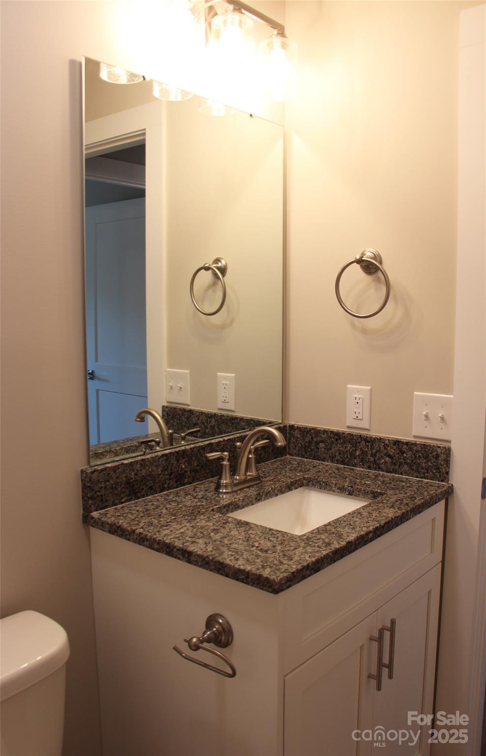 4304 Fletcher Funderburk Road Lancaster, SC 29720 - Photo 17 of 18 a bathroom with a granite countertop sink and a mirror
