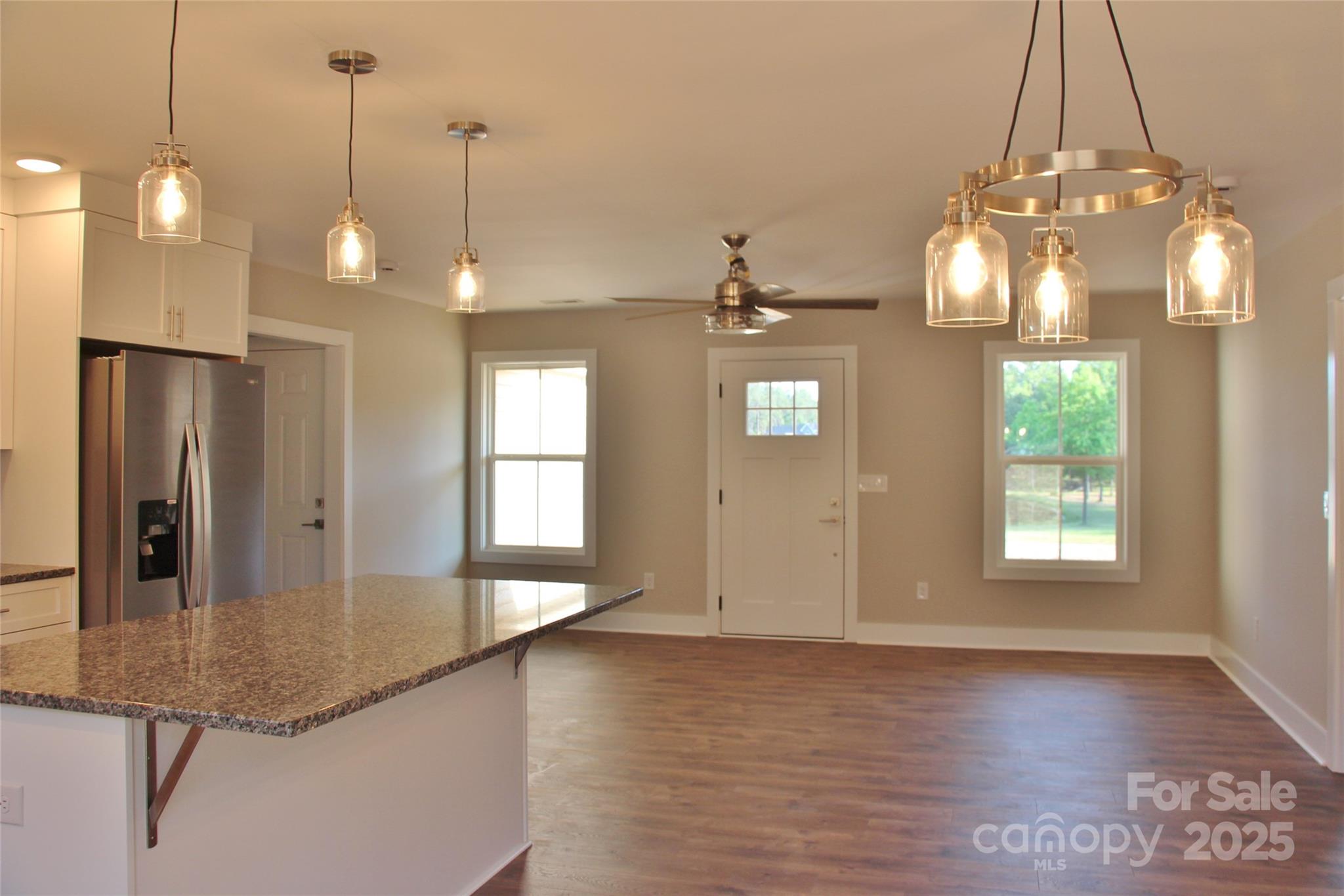 4304 Fletcher Funderburk Road Lancaster, SC 29720 - Photo 5 of 18 a view of a room with wooden floor chandelier and windows