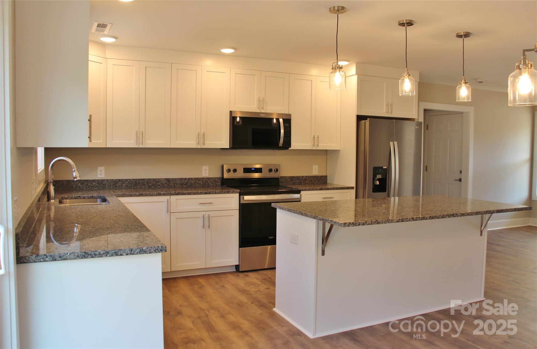 4304 Fletcher Funderburk Road Lancaster, SC 29720 - Photo 6 of 18 a kitchen with a refrigerator a sink and a stove