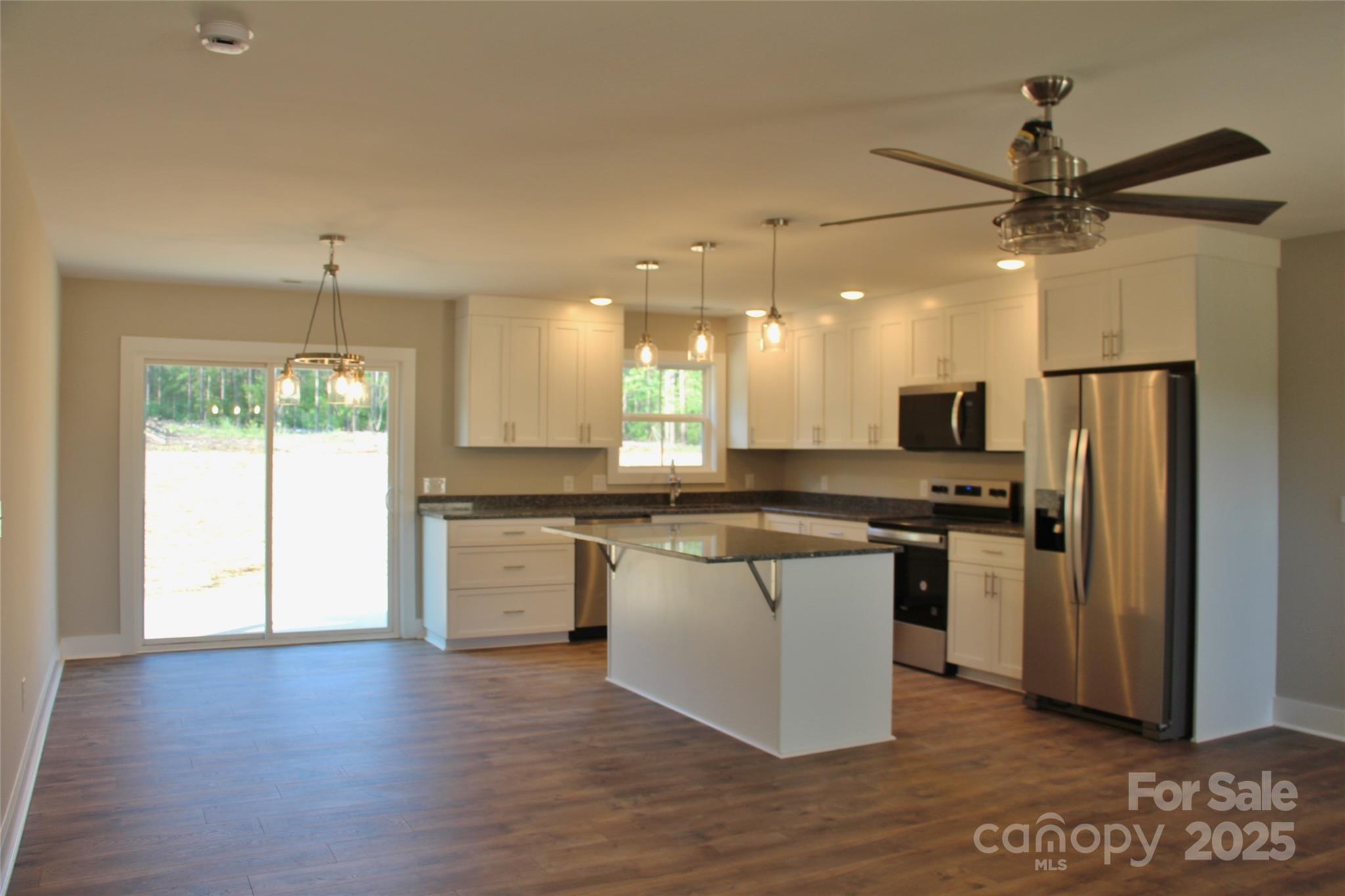 4304 Fletcher Funderburk Road Lancaster, SC 29720 - Photo 7 of 18 a kitchen with stainless steel appliances granite countertop a refrigerator a stove a sink and a microwave