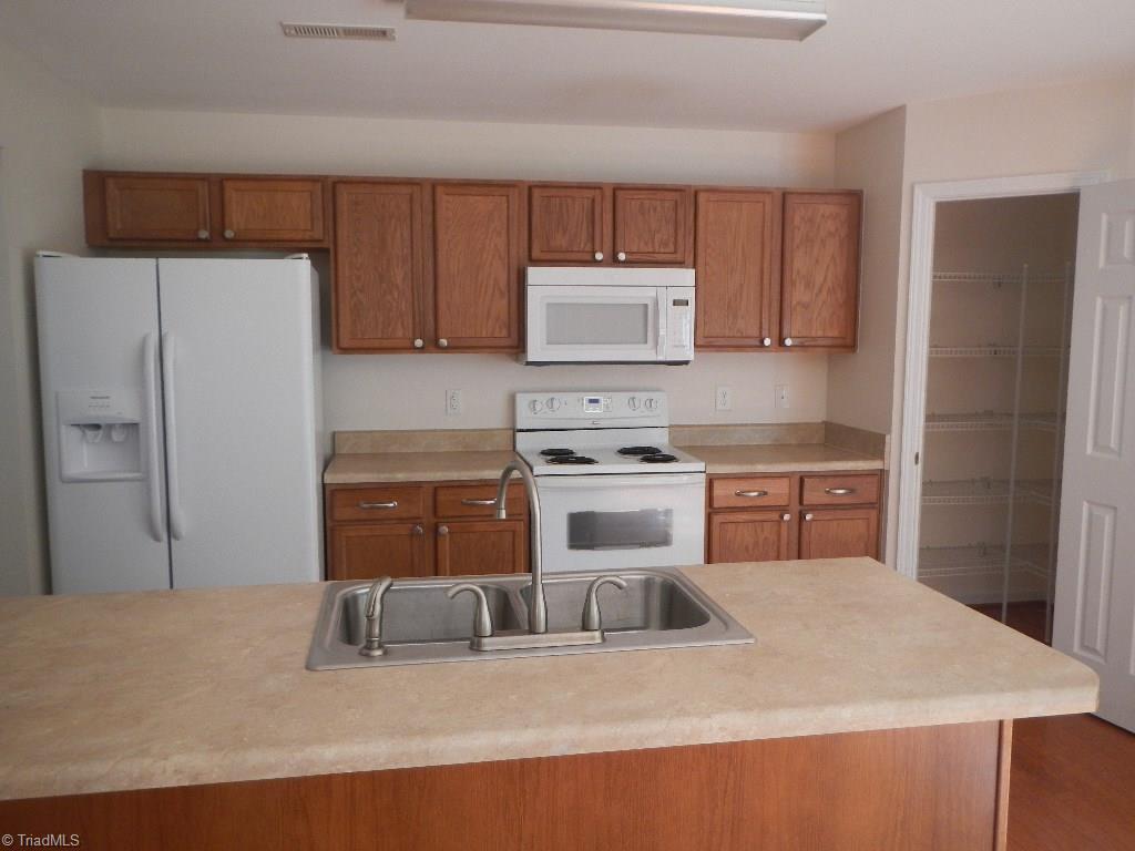 1917 Foust Road Greensboro, NC 27405 - Photo 1 of 25 Large kitchen, plenty of counter space, spacious pantry and the refrigerator stays.
