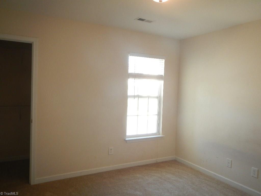 1917 Foust Road Greensboro, NC 27405 - Photo 12 of 25 Bedroom 3 with walk in closet and new carpet.