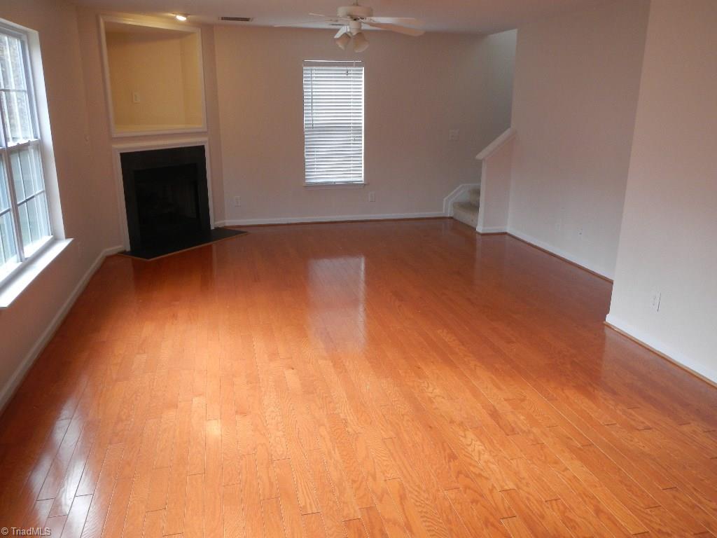1917 Foust Road Greensboro, NC 27405 - Photo 24 of 25 Open floorplan, great room is open to the kitchen. Stairs tucked away in the back. Beautiful hardwood floors and gas fireplace.