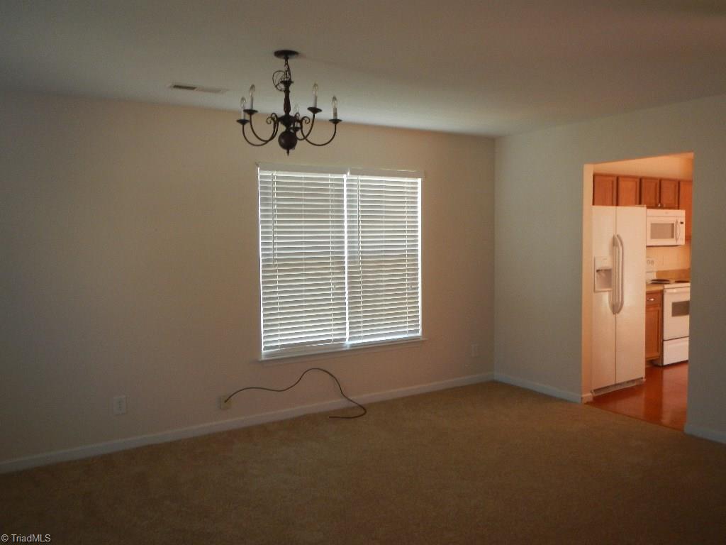 1917 Foust Road Greensboro, NC 27405 - Photo 3 of 25 Dining room, living room combination with brand new carpet.