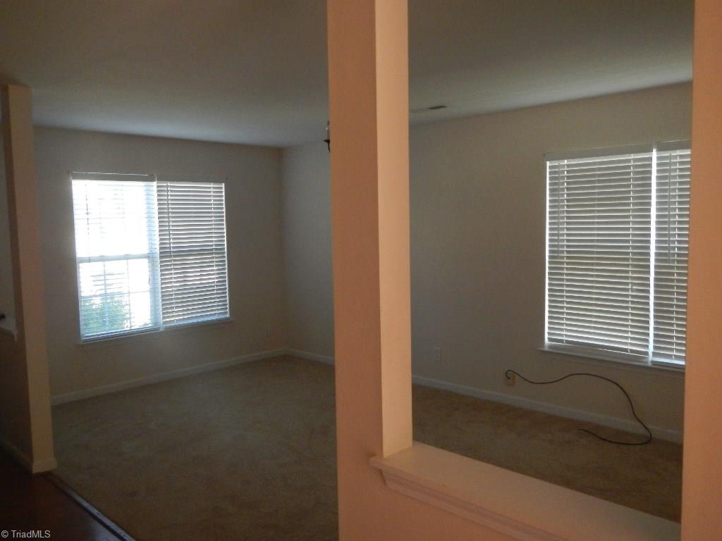 1917 Foust Road Greensboro, NC 27405 - Photo 4 of 25 Living room, dining room combo at front entry with new carpet.