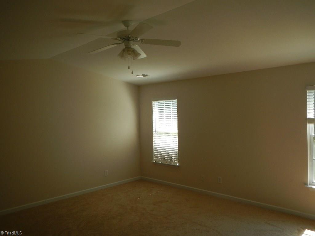 1917 Foust Road Greensboro, NC 27405 - Photo 5 of 25 Large master bedroom with cathedral ceiling, brand new carpet and two walk in closets.