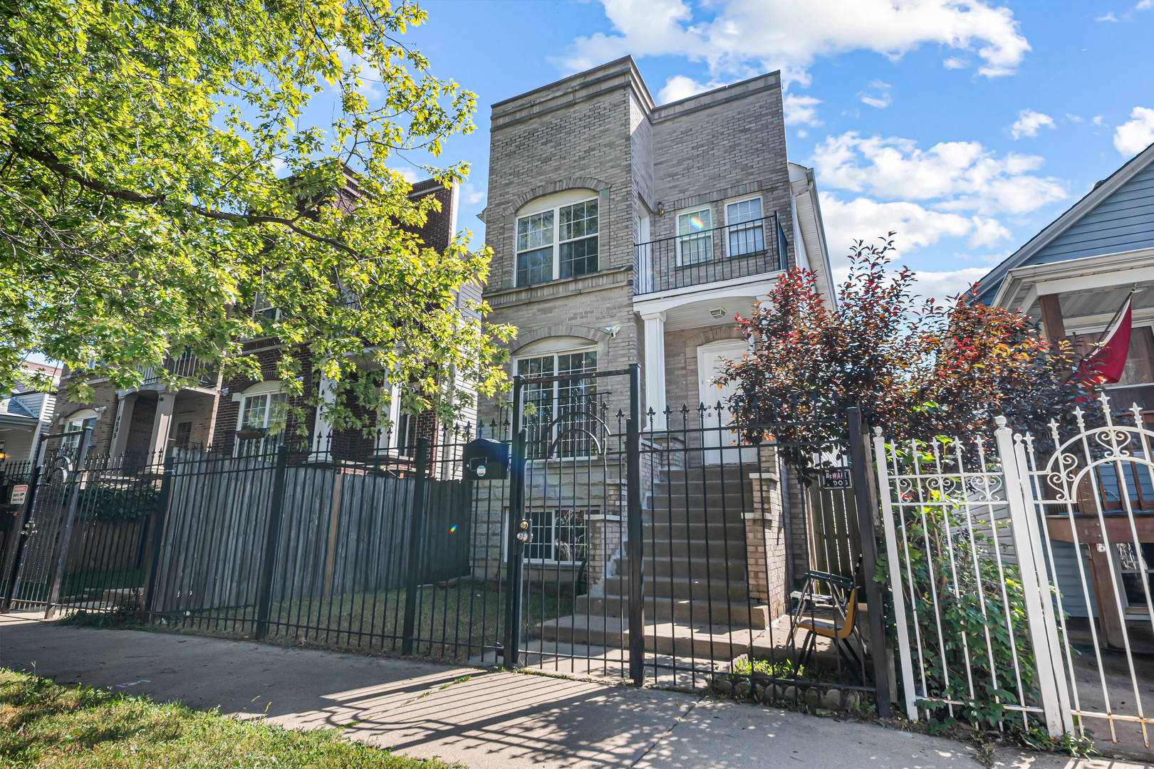 a view of a brick house next to a yard
