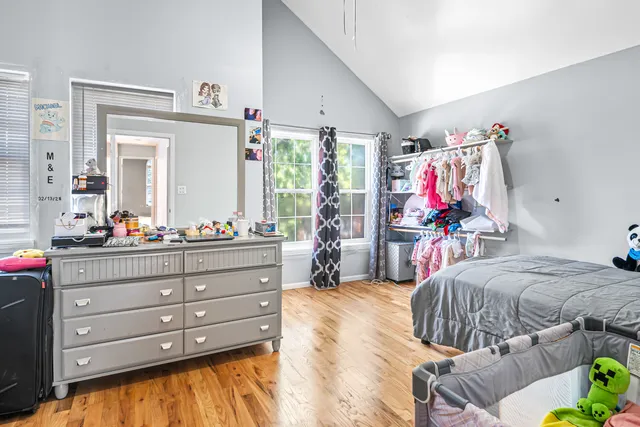 a bed room with a bed window and mirror
