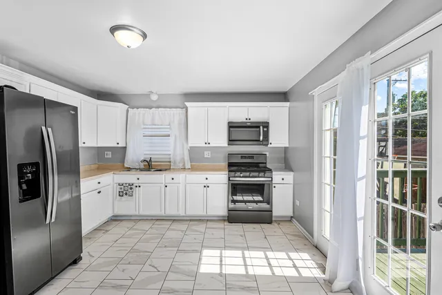 a kitchen with stainless steel appliances a refrigerator sink and stove