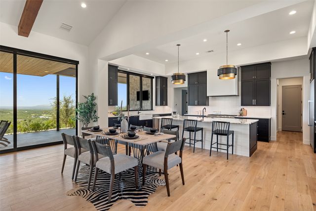 an open kitchen with a table and chairs in it