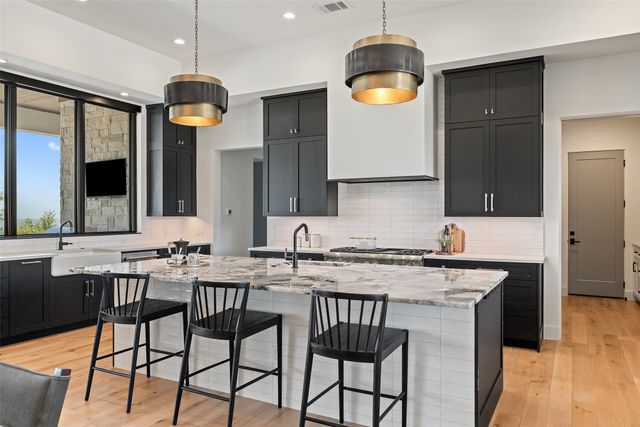a kitchen with a table chairs sink and stove