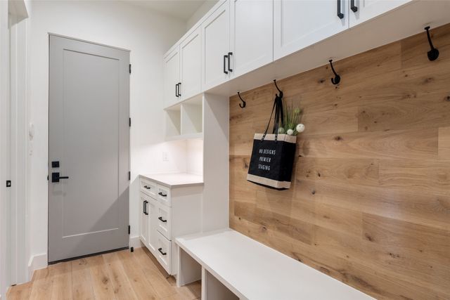 a view of an empty room with a window and a ceiling fan