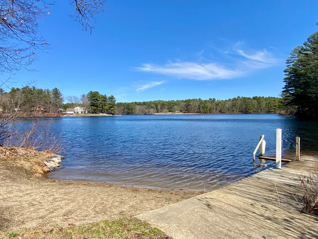 a view of a large body of water with a house in the background