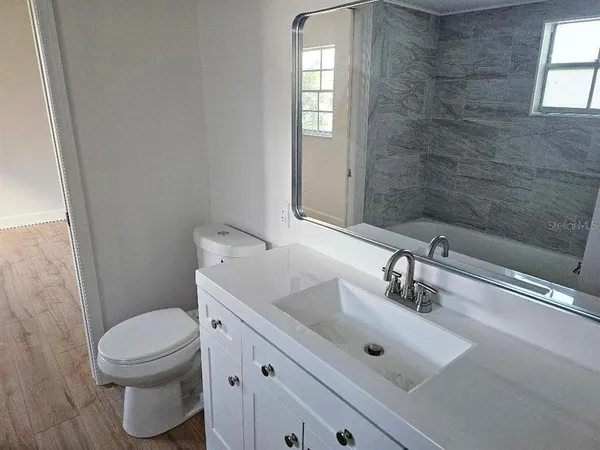 a bathroom with a sink and a window