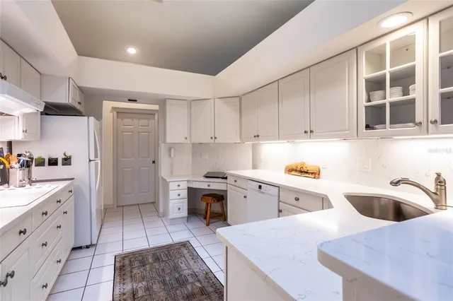 a kitchen with a sink a stove and cabinets