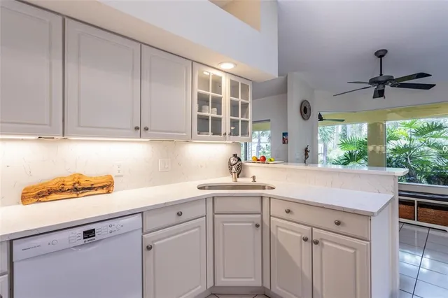 a kitchen with a sink cabinets and window