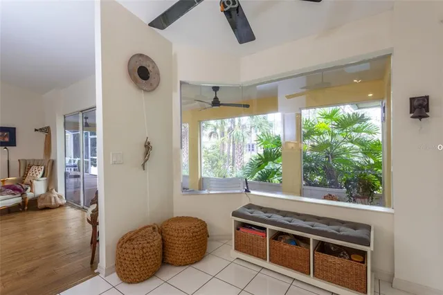 a view of a livingroom with furniture hardwood floor and windows