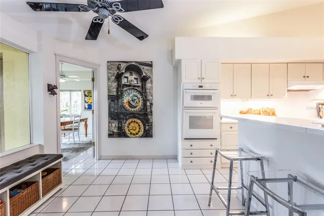a kitchen with stainless steel appliances cabinets and a window