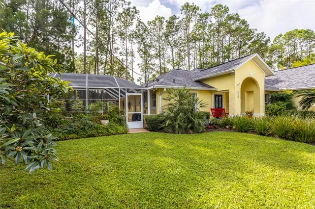 a front view of a house with a garden and yard