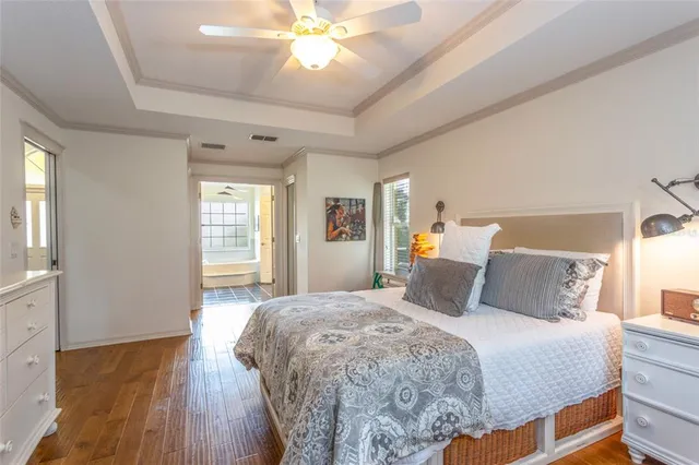 a bedroom with a large bed and a chandelier