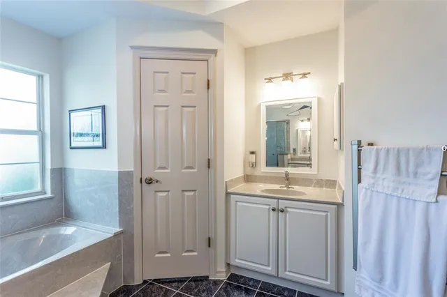 a bathroom with a granite countertop sink a toilet and shower