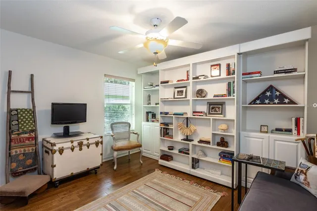 a bedroom with furniture and a book shelf