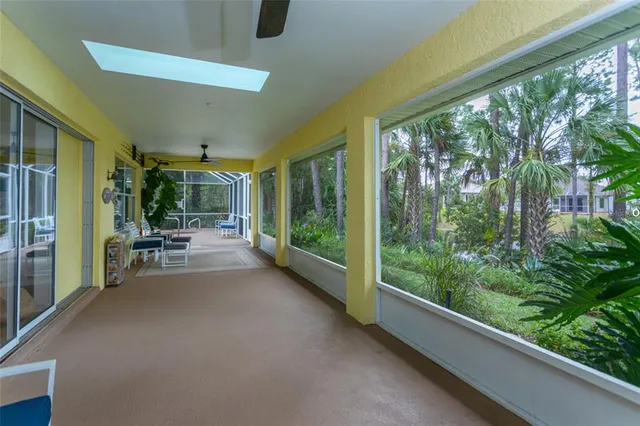 a view of a porch with chairs and backyard