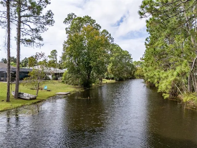 a lake view with boat and trees