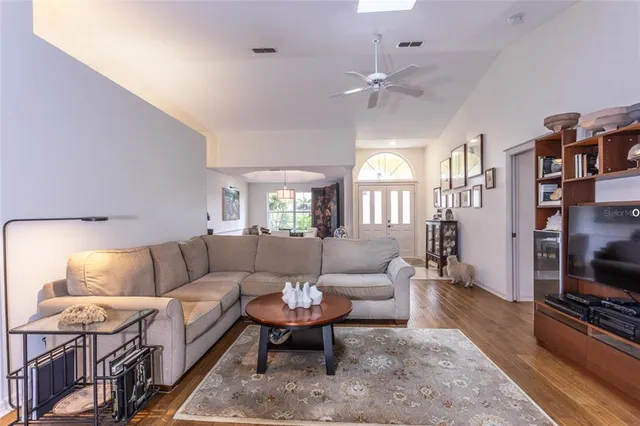 a living room with furniture a rug and a flat screen tv