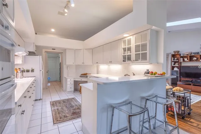 a living room with stainless steel appliances kitchen island granite countertop furniture and a kitchen view