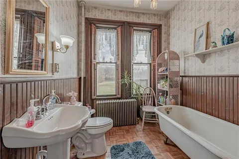 a bathroom with a sink a toilet and a mirror