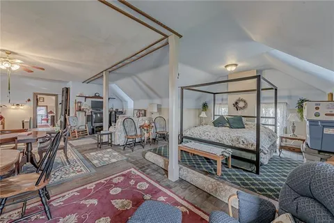 a view of a dining room and livingroom view with furniture a rug and a chandelier
