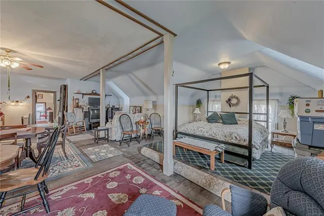 a view of a dining room and livingroom view with furniture a rug and a chandelier